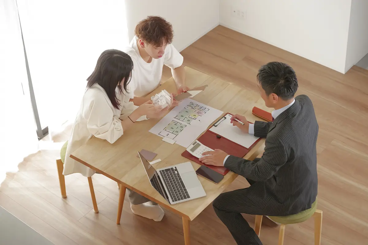 Dummy image: A smiling expert giving reassuring advice to a couple about home building